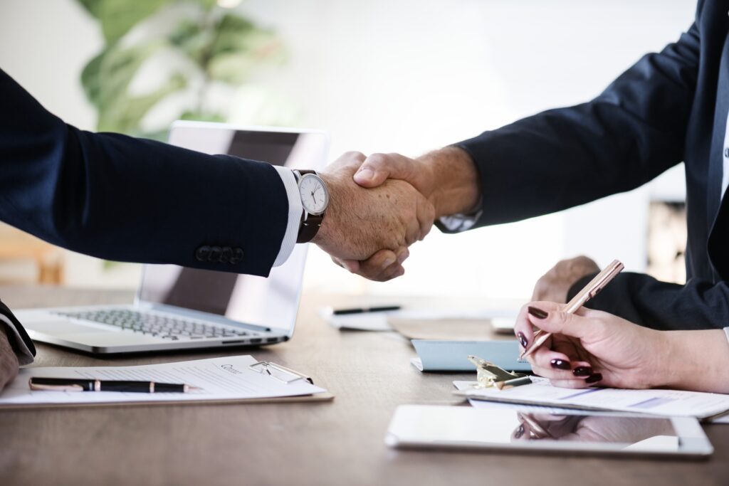 Two well-dressed men shaking hands