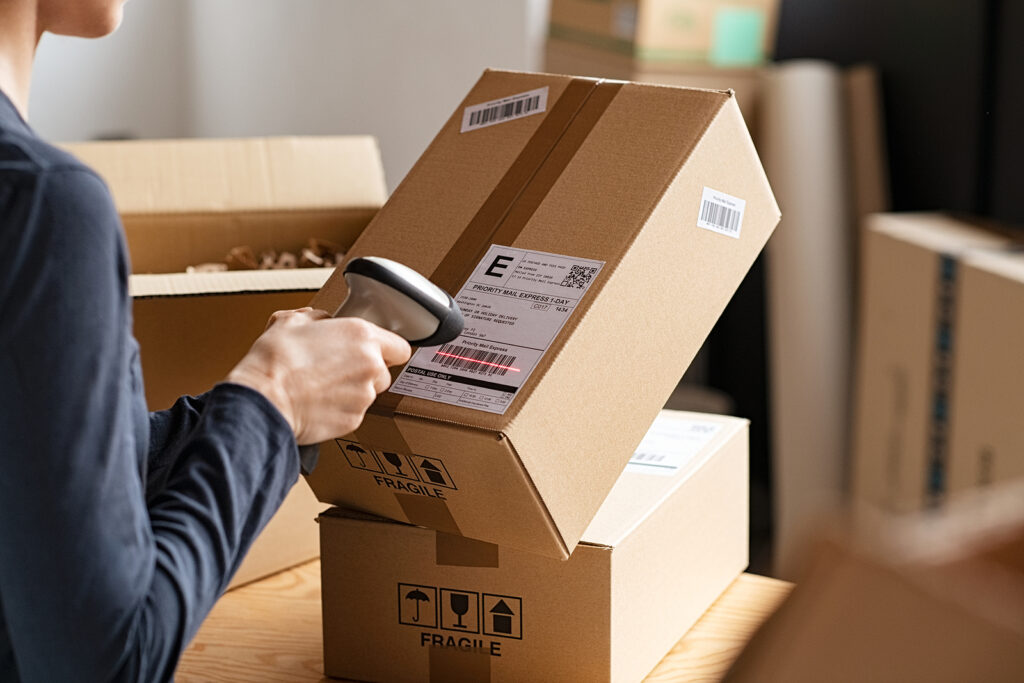 a fulfilment centre worker scanning parcels as part of delivery process