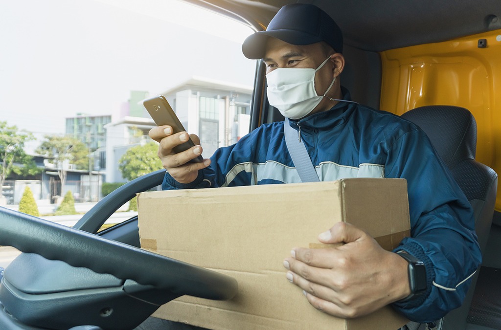 a delivery driver fulfiling eCommerce orders in his van